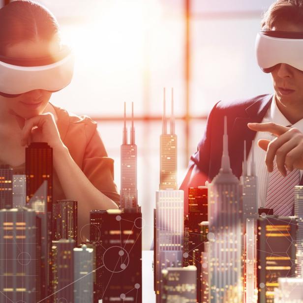 two business persons are developing a project using virtual reality goggles. the concept of technologies of the future, Virtual-Reality-Simulator, Virtuelle Realität, Innovation, Technologie, Baugewerbe, Futuristisch, Büro, Geschäftsleben, Planung, Architekturberuf, Intelligenz, Kreativität, Entwicklung, Zusammenarbeit, Frauen, Herstellendes Gewerbe, Kooperation, Bauwerk, Menschen, Forschung, Geschäftsmann, Ingenieur, Brille, Der Weg nach vorne, Erfolg, Fotografie, Modern, Strategie, Ausrüstung und Geräte, Gelegenheit, Idee, Künstlich, Software, Ungestellt, Verbindung, Aktivitäten und Sport, Erwachsene Person, Finanzwirtschaft und Industrie, Genie, Geschäftsstrategie, Gesichtsausdruck, Horizontal, Interaktivität, Männer, Platzieren, Schreibtisch, Sehen, Vorstellungskraft, Wachstum, Bildnummer 518588784