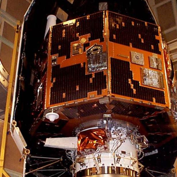 Ein Satellit wird in einer Montagehalle vorbereitet.