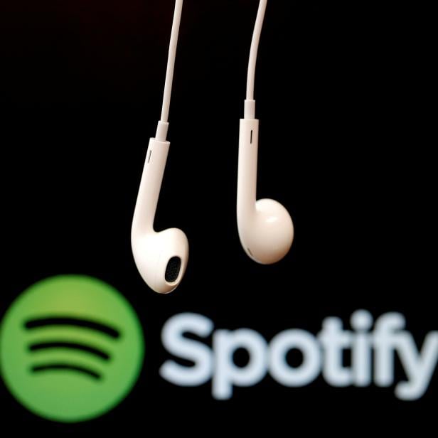 FILE PHOTO: Headphones are seen in front of a logo of online music streaming service Spotify