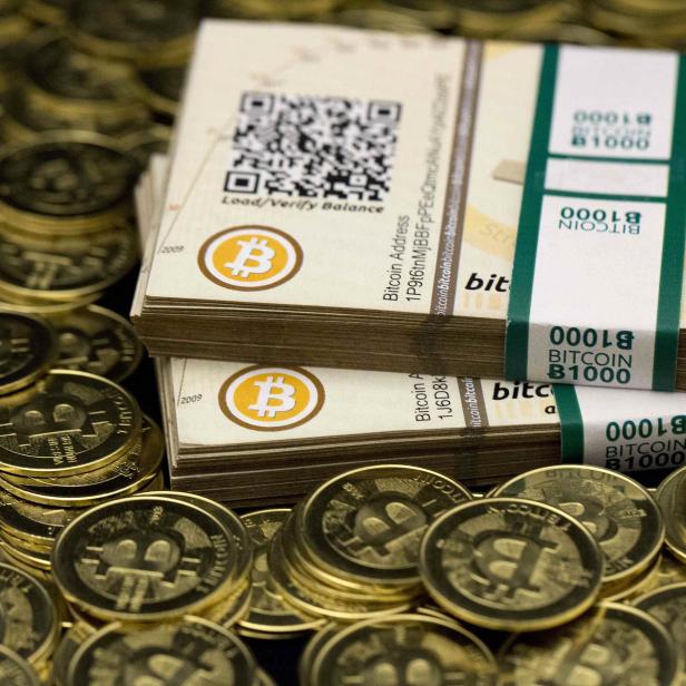 Some of Bitcoin enthusiast Mike Caldwell's coins and paper vouchers often called "paper wallets" are pictured at his office in Sandy, Utah