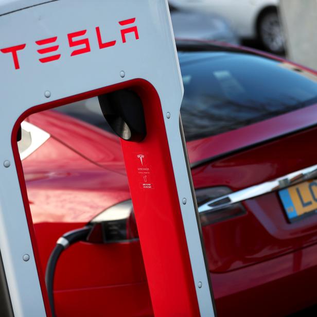 A Tesla car is charged at a Tesla dealership in West Drayton, just outside London