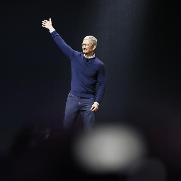 Tim Cook waves during Apple's annual developer conference in San Jose