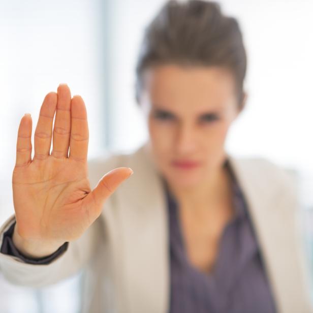 closeup on business woman in office showing stop gesture