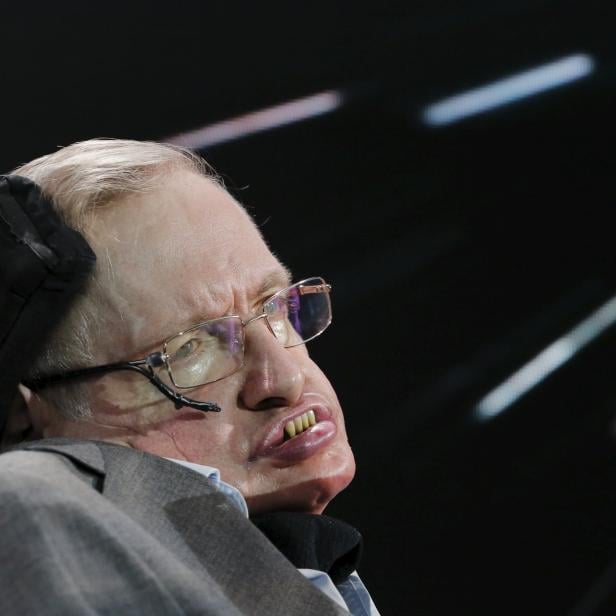 Physicist Stephen Hawking sits on stage during an announcement of the Breakthrough Starshot initiative with investor Yuri Milner in New York 