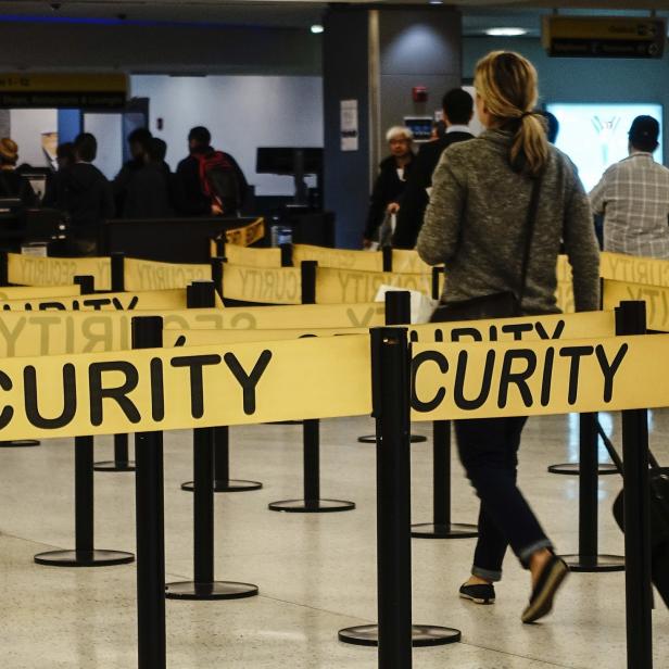 Passengers make their way in a security checkpoint at the International JFK airport in New York