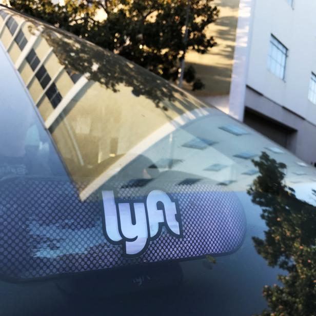 An illuminated sign appears in a Lyft ride-hailing car in Los Angeles