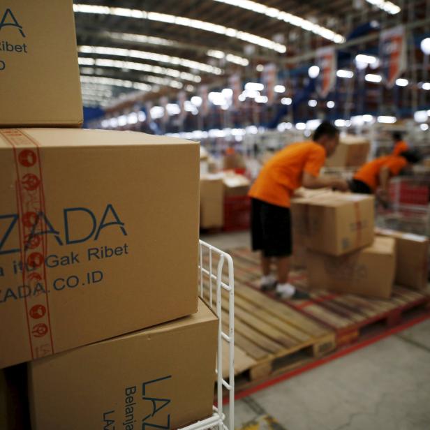 Employees at online retailer Lazada fill orders at the company's warehouse in Jakarta, Indonesia