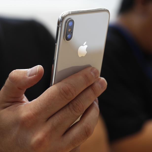 Attendee checks out new iPhone X during an Apple launch event in Cupertino