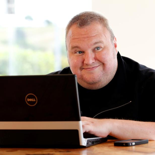 FILE PHOTO: Kim Dotcom smiles during an interview with Reuters in Auckland