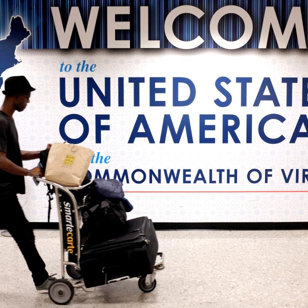 FILE PHOTO: A man exits the transit area after clearing immigration and customs on arrival at Dulles International Airport in Dulles