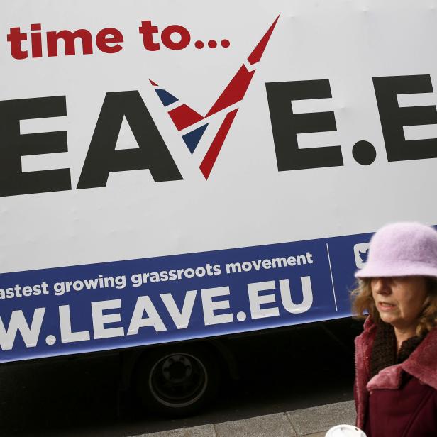 A woman walks past a Leave.EU campaign mobile advertising board in central London