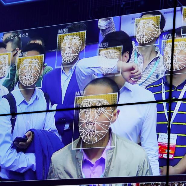Visitors experience facial recognition technology at Face++ booth during the China Public Security Expo in Shenzhen