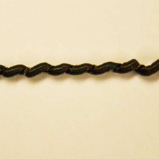 Ein schwarzes, gedrehtes Textilkabel liegt auf einem hellen Untergrund.