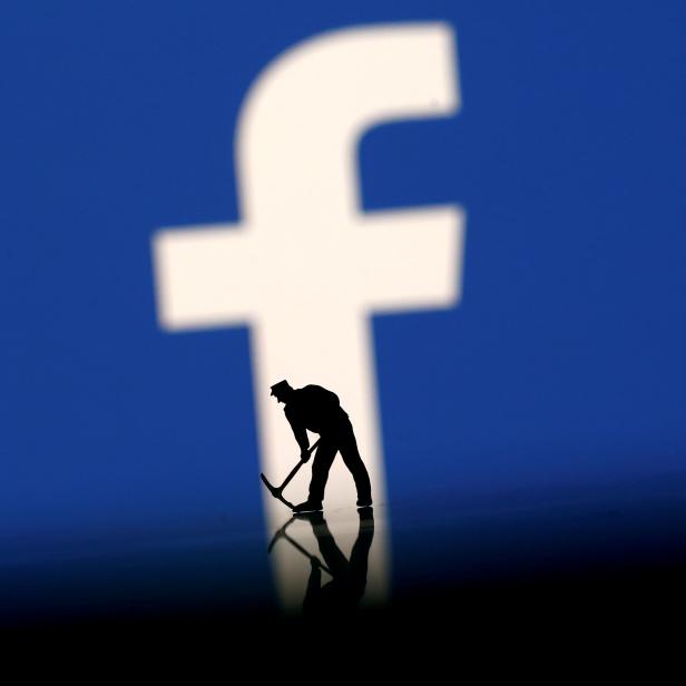 FILE PHOTO: A figurine is seen in front of the Facebook logo in this illustration