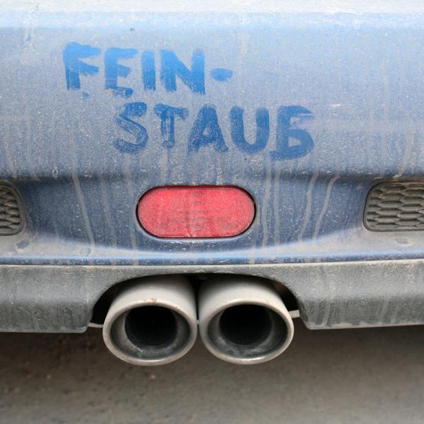 Auf der staubbedeckten Heckklappe eines Autos steht „Feinstaub“ geschrieben.