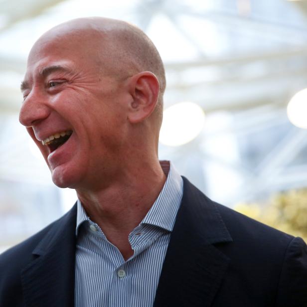 Amazon founder and CEO Jeff Bezos laughs as he talks to the media while touring the new Amazon Spheres during the grand opening in Seattle