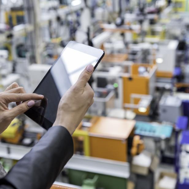 Female manager working on tablet in factory