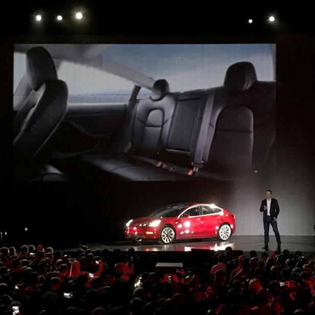 FILE PHOTO: Tesla Chief Executive Elon Musk introduces one of the first Model 3 cars in Fremont California