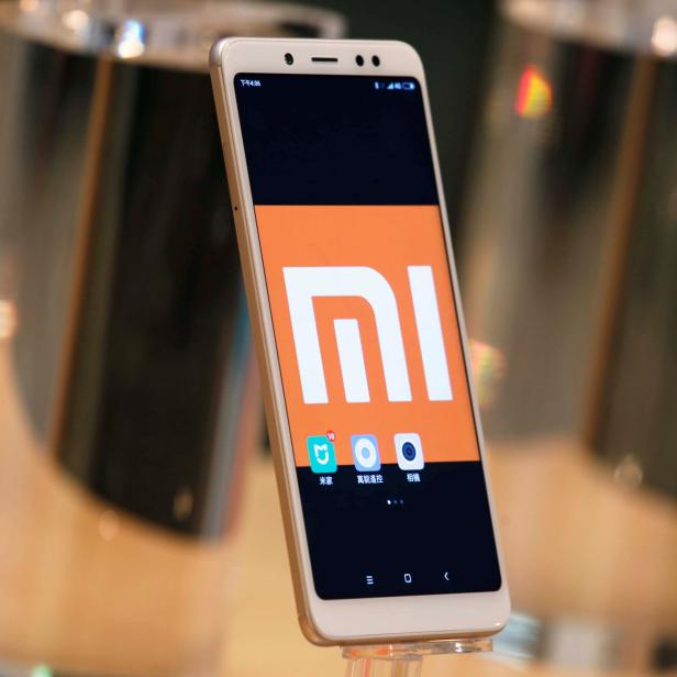 A company logo of Xiaomi is displayed on its smartphone in Hong Kong