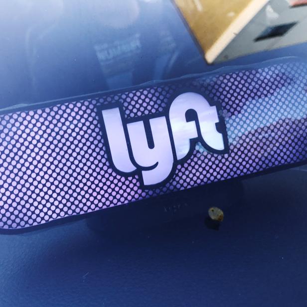 An illuminated sign appears in a Lyft ride-hailing car in Los Angeles