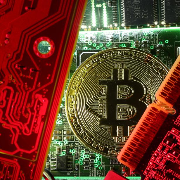 FILE PHOTO: Copy of bitcoin standing on PC motherboard is seen in this illustration picture