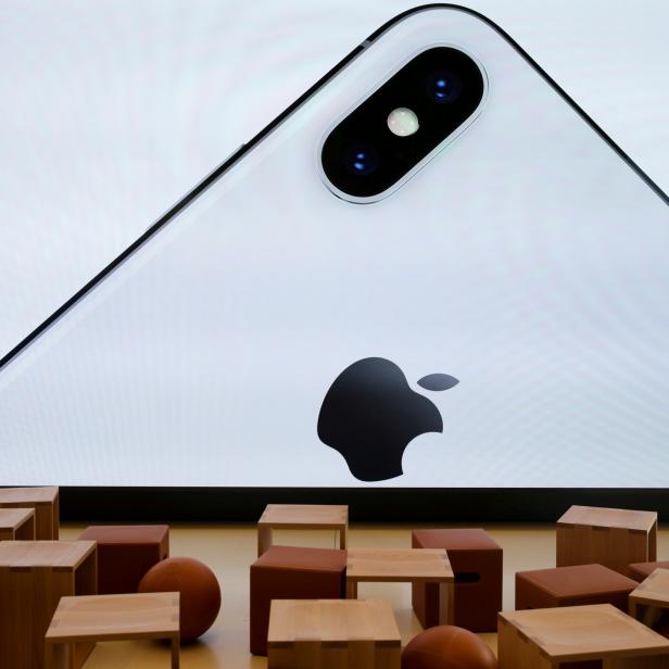 FILE PHOTO: An iPhone X is seen on a large video screen in the new Apple Visitor Center in Cupertino