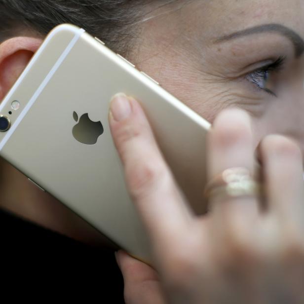 A woman uses her mobile phone in Munich