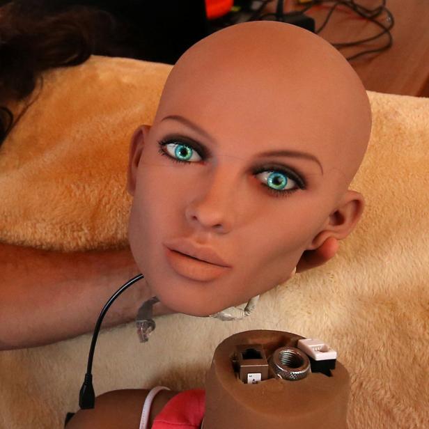 Catalan nanotechnology engineer Sergi Santos holds the head of Samantha, a sex doll packed with artificial intelligence providing her the capability to respond to different scenarios and verbal stimulus, in his house in Rubi, north of Barcelona