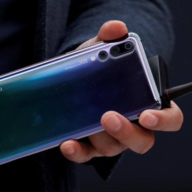 FILE PHOTO: Richard Yu, CEO of the Huawei Consumer Business Group, holds a Huawei P20 smartphone during the launching of the new generation of its smartphone in Paris