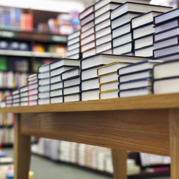 Books stacked on table at bookstore