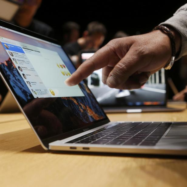 A guest points to a new MacBook Pro during an Apple media event in Cupertino