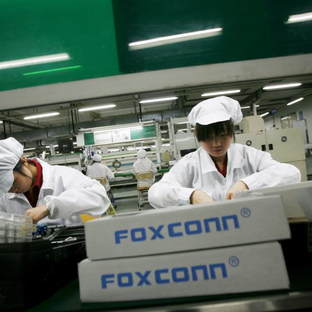 File photo of employees working inside a Foxconn factory in the township of Longhua, China