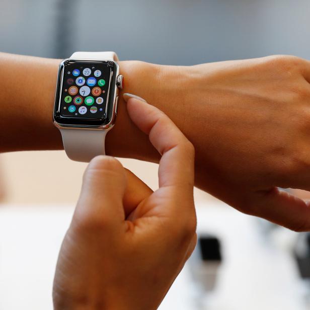 A woman tries a new Apple Watch Series 3 Cellular model after it goes on sale at the Apple Store in Tokyo's Omotesando shopping district