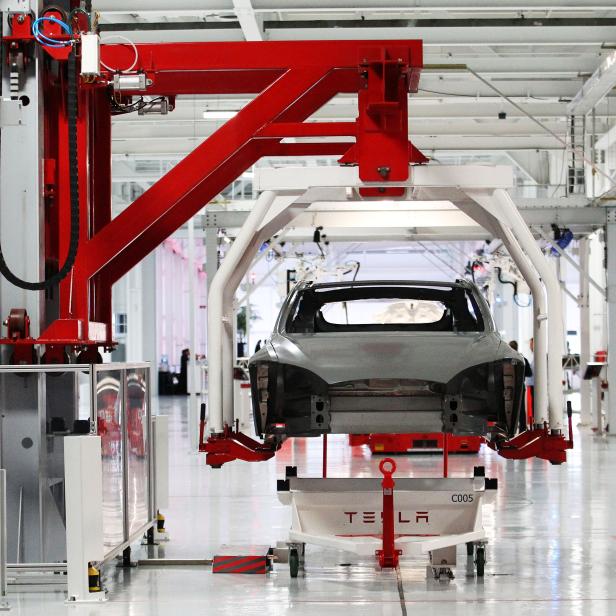 FILE PHOTO --  The body of a Tesla Model S is lifted by an automated crane at the Tesla factory in Fremont