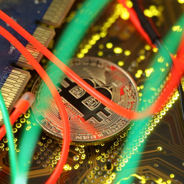 FILE PHOTO: Representation of the Bitcoin virtual currency standing on the PC motherboard is seen in this illustration picture