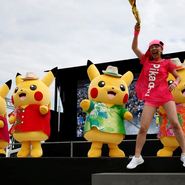 FILE PHOTO: Performers in Pikachu costumes dance at a Splash show and Pokemon Go Park event in Yokohama