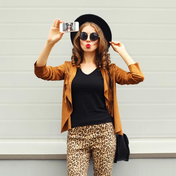 Fashion woman model taking photo picture self-portrait on smartphone