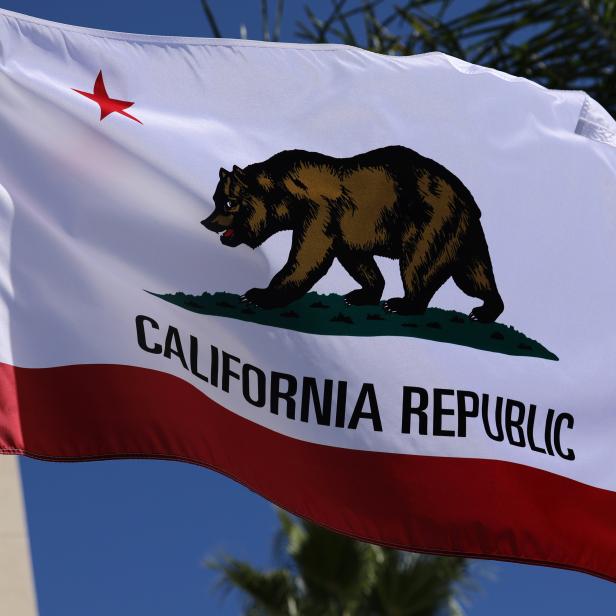 The state flag of California flies on a flag pole in San Diego