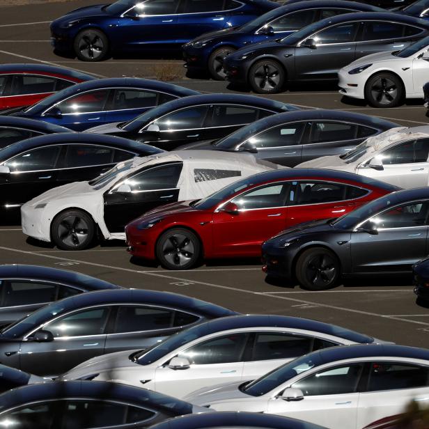 Rows of new Tesla Model 3 electric vehicles are seen in Richmond, California.