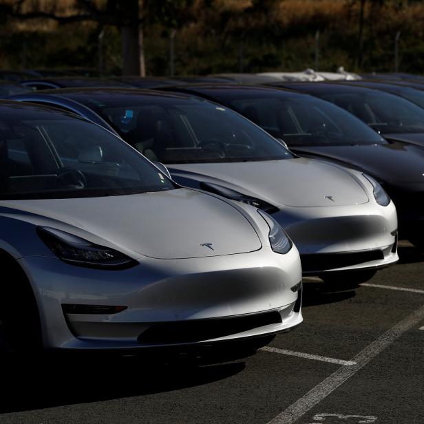 FILE PHOTO: A row of new Tesla Model 3 electric vehicles is seen at a parking lot in Richmond California