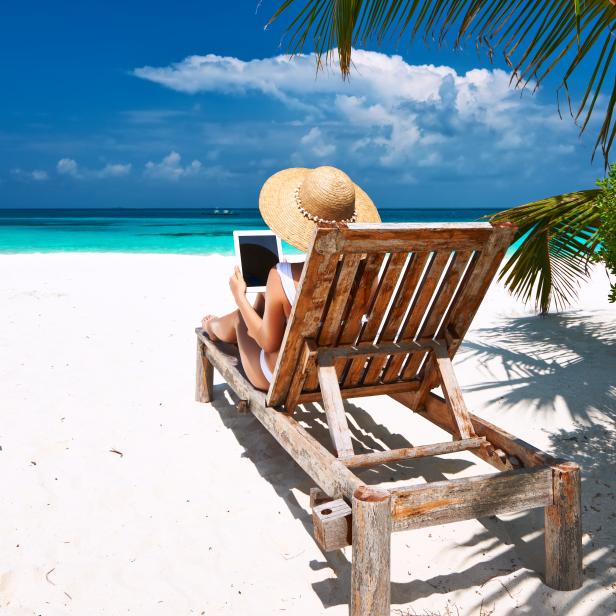 Young woman with tablet pc at the beach