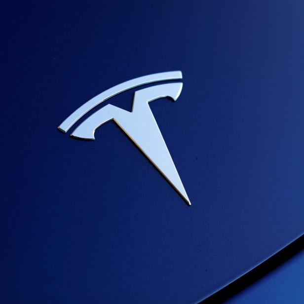 FILE PHOTO: The front hood logo on a 2018 Tesla Model 3 electric vehicle is shown in Cardiff, California