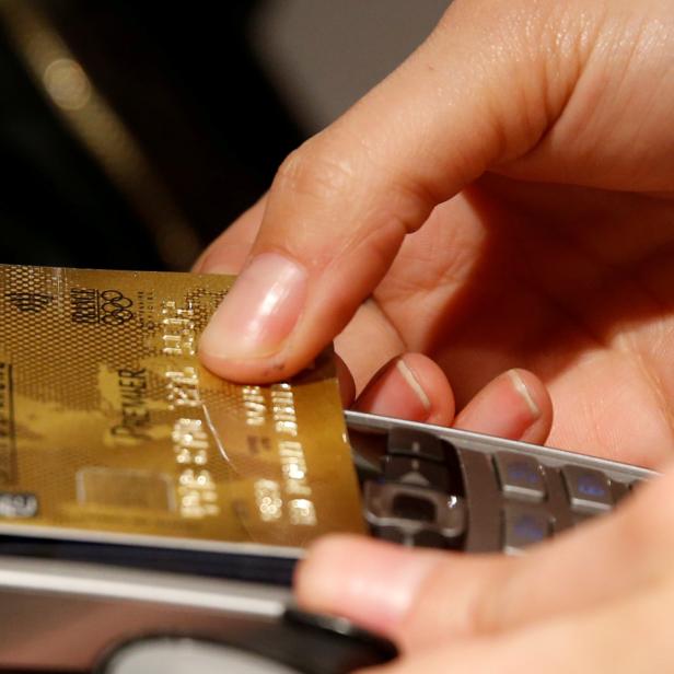 FILE PHOTO: A customer pays with a credit card at a store in Paris