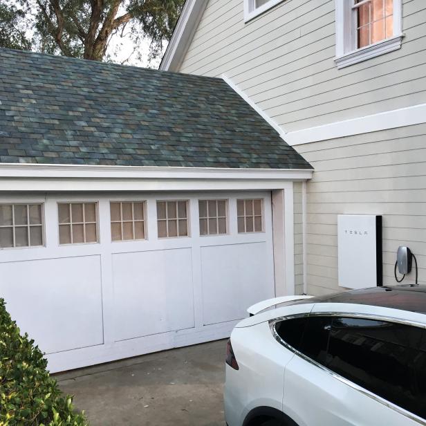 Tesla's electric car, Powerwall and solar roof are shown at an unveiling of new energy products aimed at illustrating the benefits of combining his electric car and battery maker with solar installer SolarCity Corp, in Los Angeles