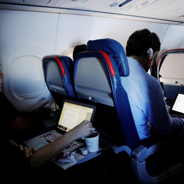 FILE PHOTO --  Passengers use their laptops on a flight out of JFK International Airport in New York