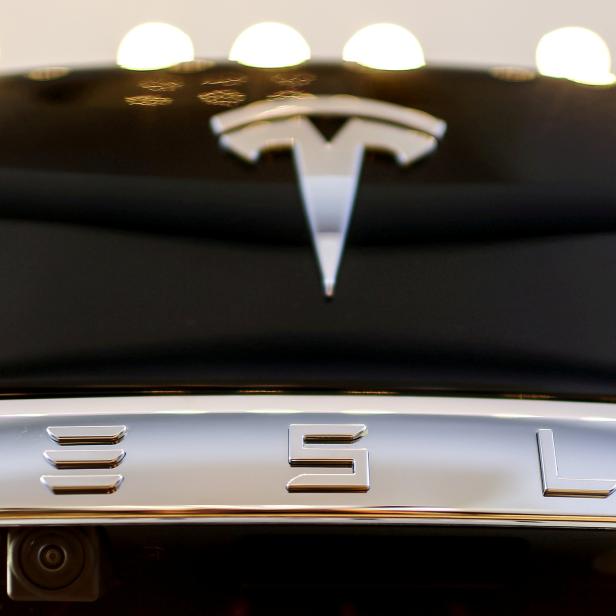 FILE PHOTO: A Tesla logo adorns a 'Model S' car in the dealership in Berlin