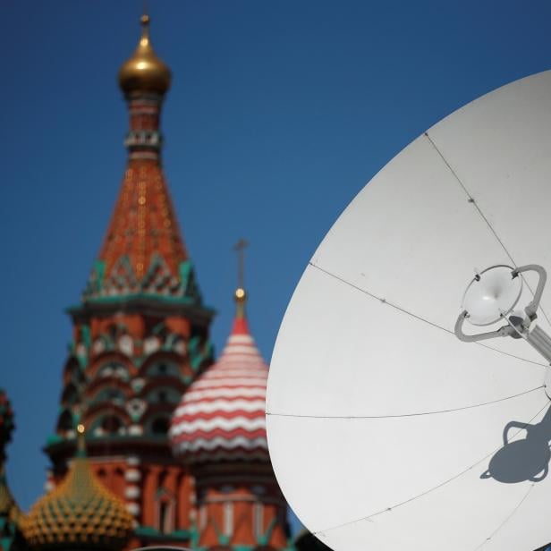 A TV satellite dish is seen in front of St. Basil's Cathedral in central Moscow