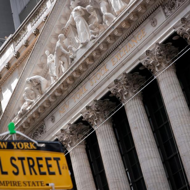 A novelty Wall St. sign is displayed at a stand outside the NYSE in New York