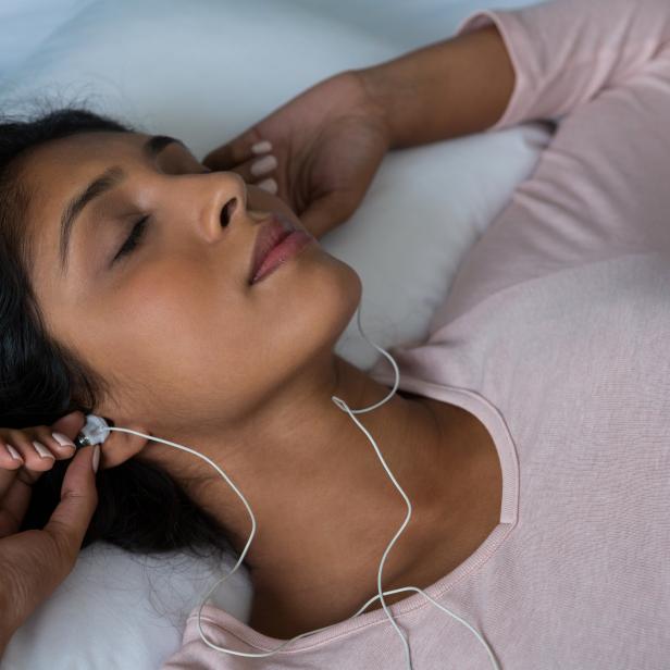 Woman sleeping while listening to music