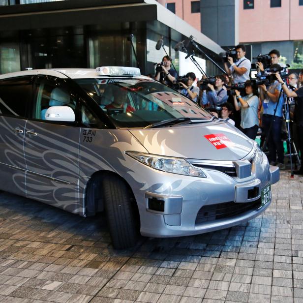 ZMP Inc's RoboCar MiniVan, a self-driving taxi based on a Toyota Estima Hybrid car, operated by Hinomaru Kotsu Co, is seen at the start of its services proving test in Tokyo